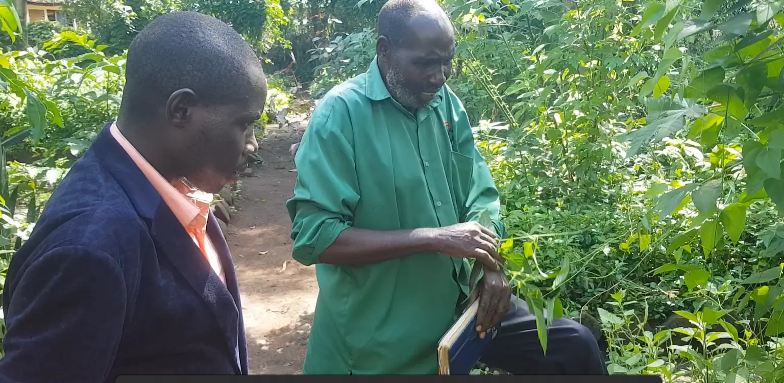 Twesiime Paulino engaging a community member on ethnomedicine
